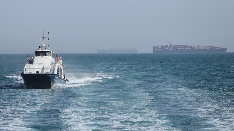 PHOTO: A patrol boat moves through the water as cargo ships sit at anchor in the Strait of Hormuz off Bandar Abbas, Iran, May 2, 2026.