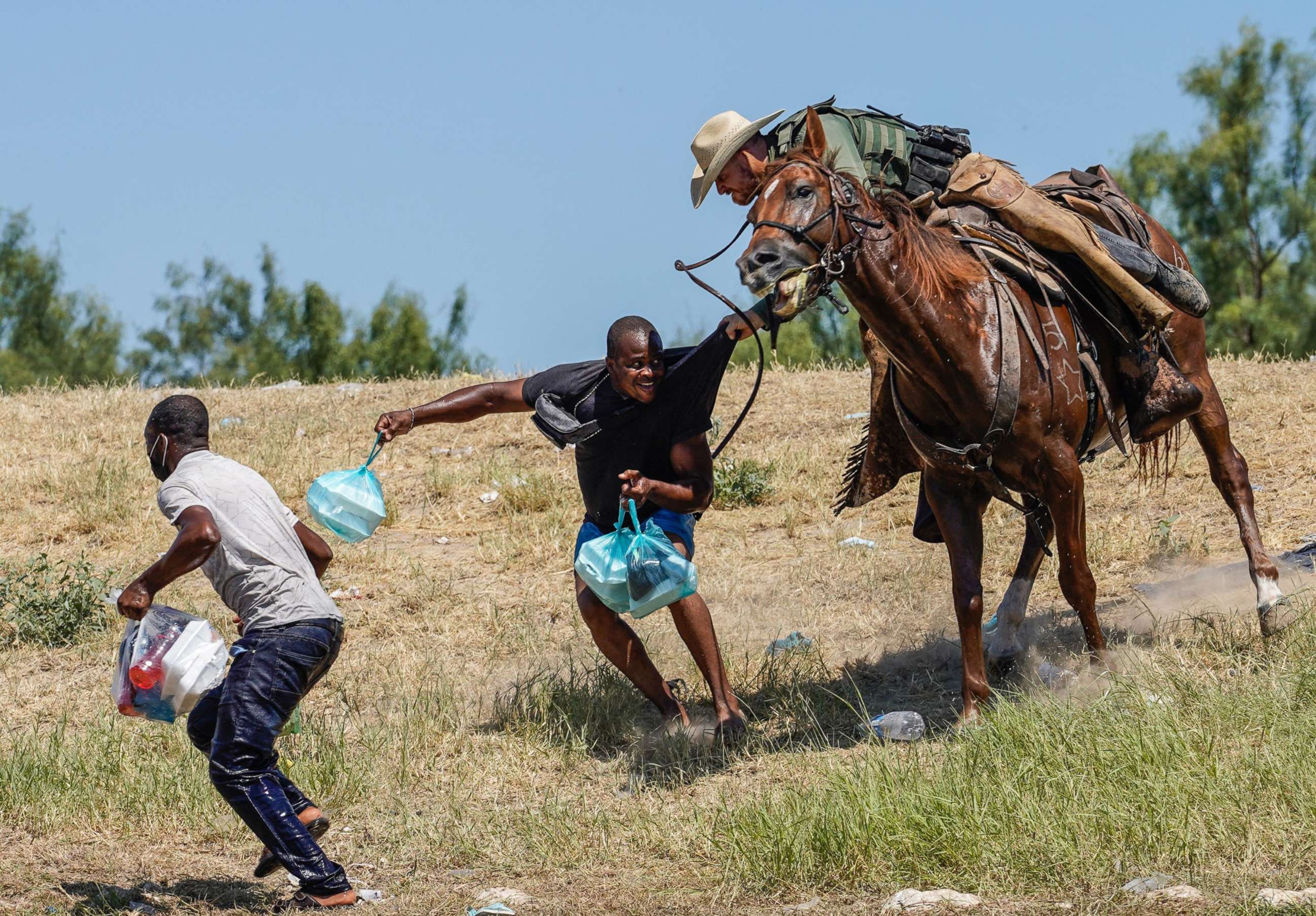 PHOTO: A United States Border Patrol agent on horseback tries to stop a Haitian migrant from entering an encampment on the banks of the Rio Grande near the Acuna Del Rio International Bridge in Del Rio, Texas on Sept. 19, 2021. 