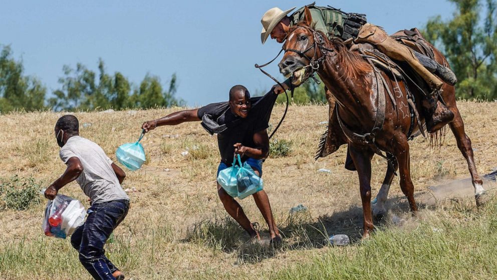 PHOTO: A United States Border Patrol agent on horseback tries to stop a Haitian migrant from entering an encampment on the banks of the Rio Grande near the Acuna Del Rio International Bridge in Del Rio, Texas on Sept. 19, 2021. 