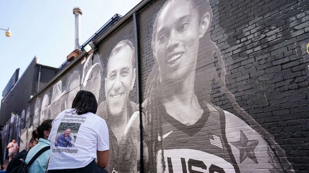 PHOTO: People visit a mural of Brittney Griner and other hostages around the world created by the Bring Our Families Home Campaign, a campaign for Americans wrongfully detained or held hostage abroad, in Washington, D.C., July 20, 2022.