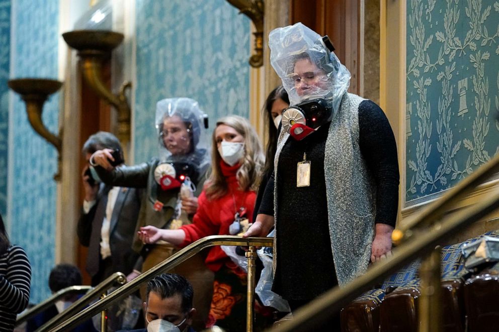 PHOTO: People are seen in the House gallery wearing emergency gas masks as rioters try to break into the House chamber at the U.S. Capitol, Jan. 6, 2021, in Washington.
