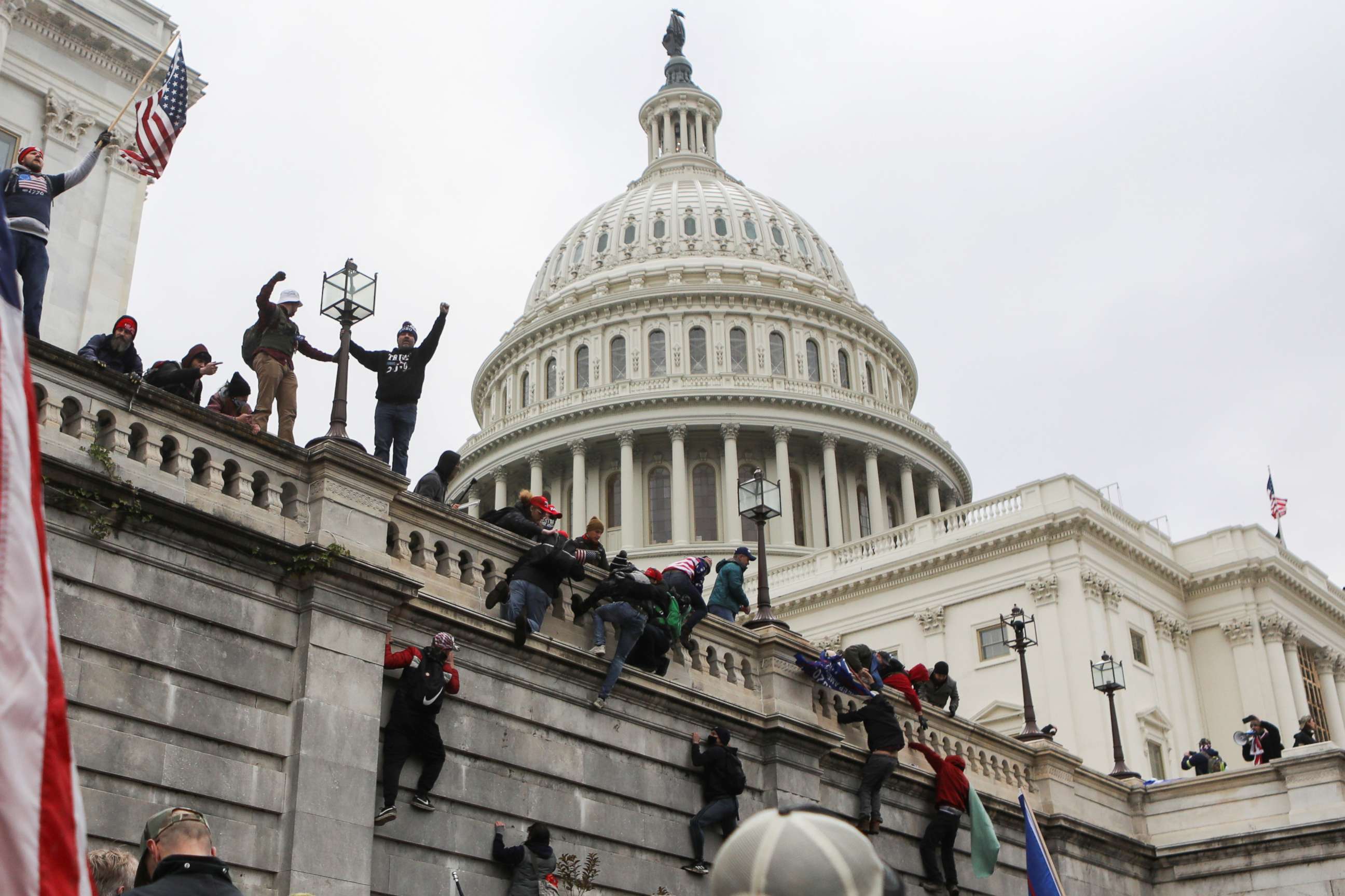 PHOTO: Supporters of President Donald Trump climb on walls at the U.S. Capitol during a protest against the certification of the 2020 U.S. presidential election results by Congress, in Washington, Jan. 6, 2021.