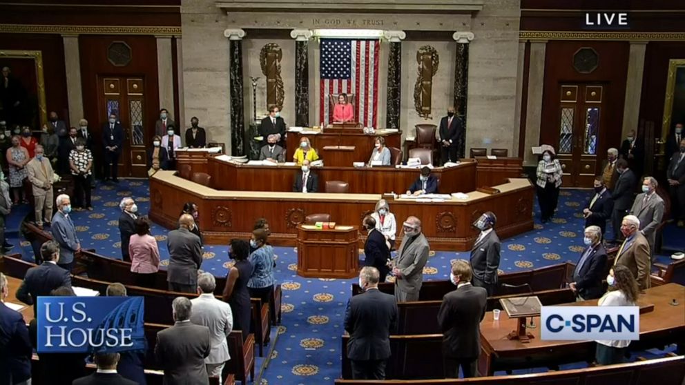 PHOTO: Members stand as the House of Representatives pays tribute to Rep. John Lewis on the floor of the U.S. House of Representatives in Washington, July 20, 2020.