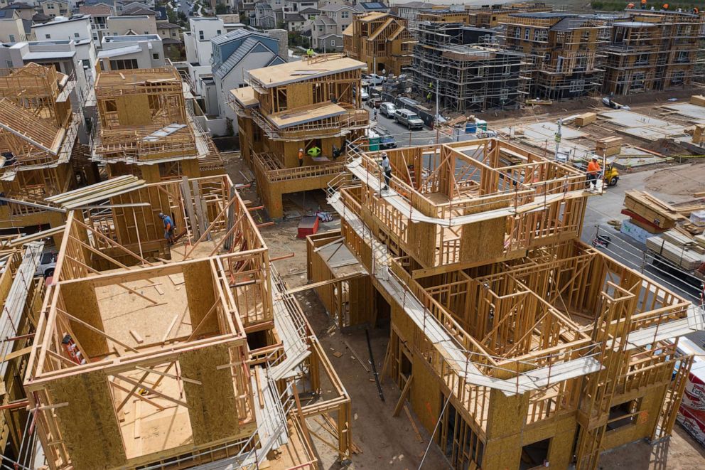 PHOTO: Contractors work on single-family homes under construction in the Cadence Park development in Irvine, Calif., April 14, 2021.