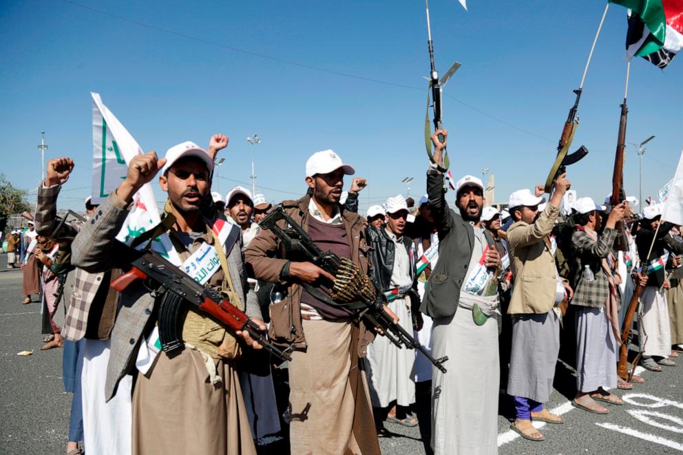 PHOTO: Yemenis trained by the Houthi movement hold their guns and chant slogans as they take part in a parade in Al-Sabeen Square, Dec. 2, 2023, in Sanaa, Yemen.