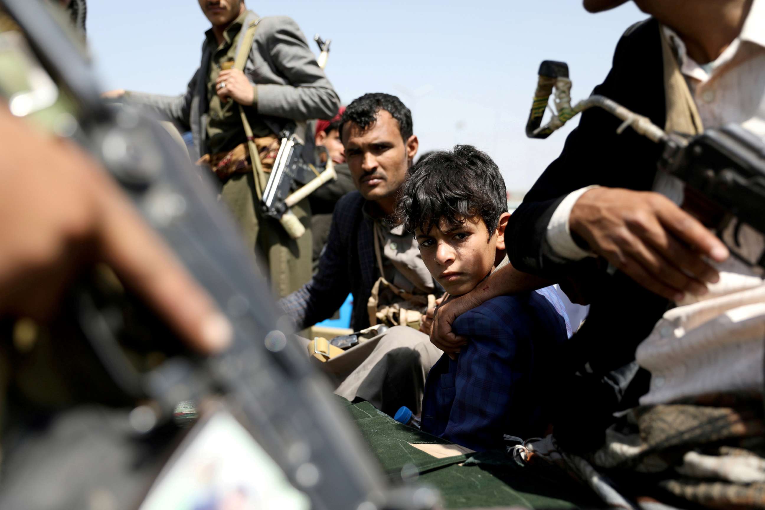 PHOTO: A boy rides with Houthi followers on the back of a patrol truck during the funeral of Houthi fighters killed during recent battles against government forces, in Sanaa, Yemen, Sept. 22, 2020. 