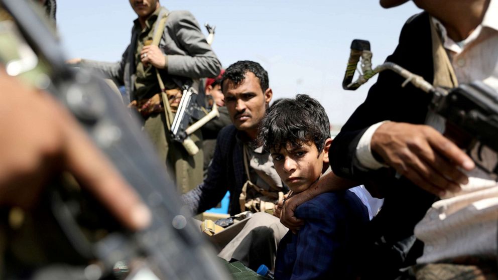 PHOTO: A boy rides with Houthi followers on the back of a patrol truck during the funeral of Houthi fighters killed during recent battles against government forces, in Sanaa, Yemen, Sept. 22, 2020. 