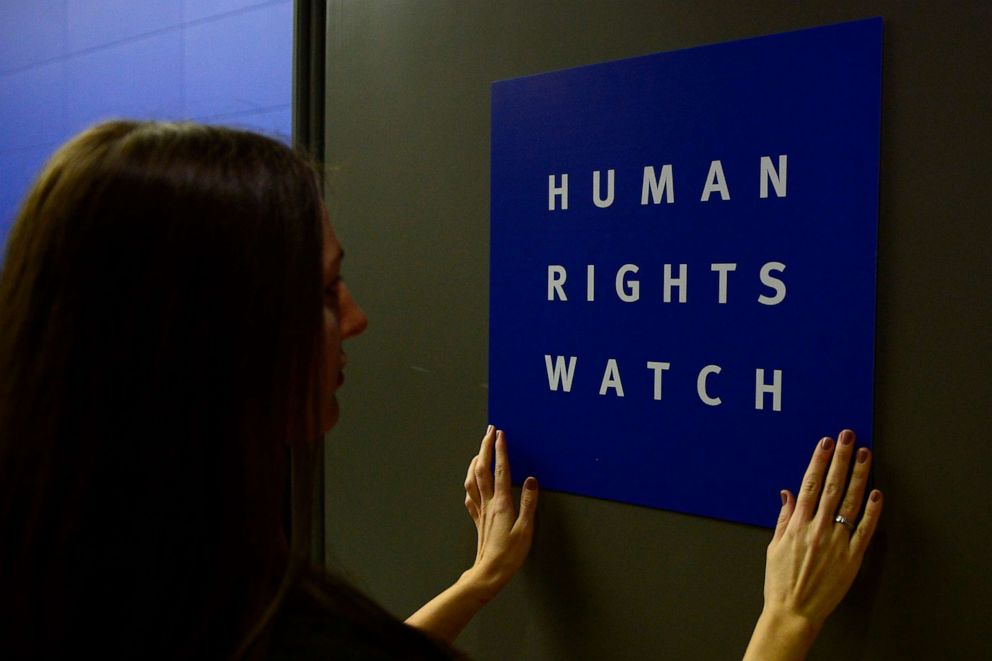 PHOTO: A woman puts a logo of US-based rights group Human Rights Watch on the door as she prepares the room before their press conference to release their annual World report, Jan. 21, 2014, in Berlin.