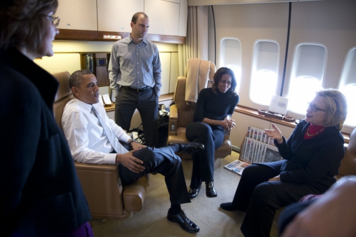 Former Secretary of State Hillary Clinton talks with the Obama's, Ben Rhodes and Capricia Marshall aboard Air Force One, Dec. 9, 2013. 