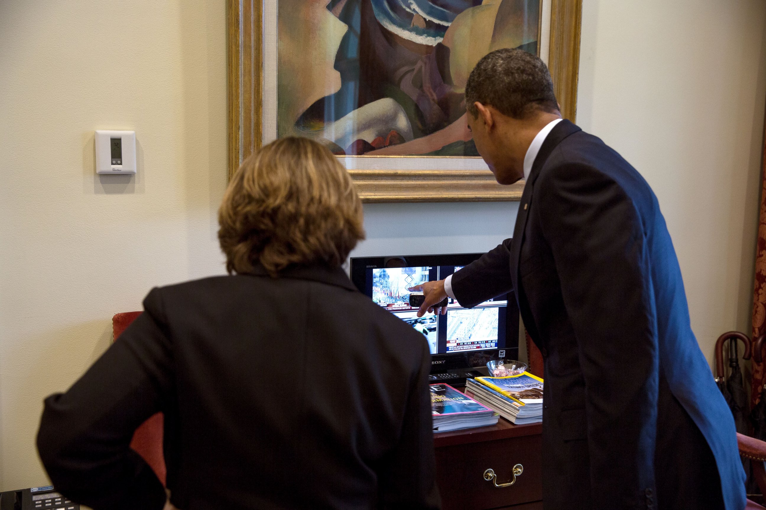 PHOTO: President Barack Obama watches television coverage of the Boston Marathon bombings with Lisa Monaco in the Outer Oval Office, April 15, 2013.