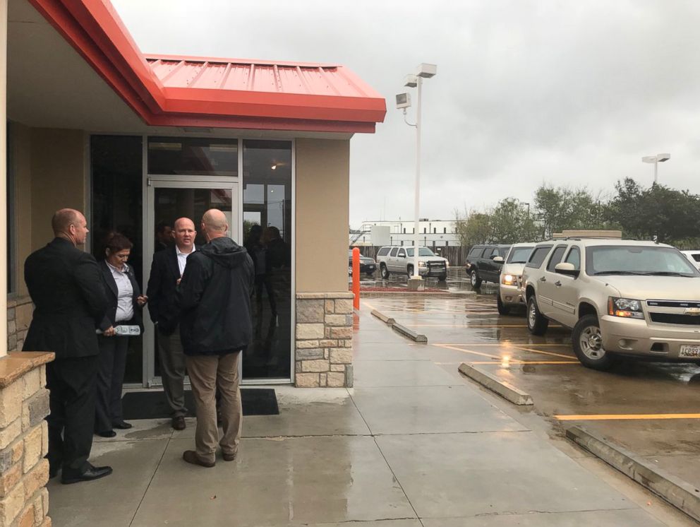 PHOTO: Secret service wait outside a Whataburger in Corpus Christi, Texas, on December 6, 2017, while first lady Melania Trump and second lady Karen Pence order inside. 