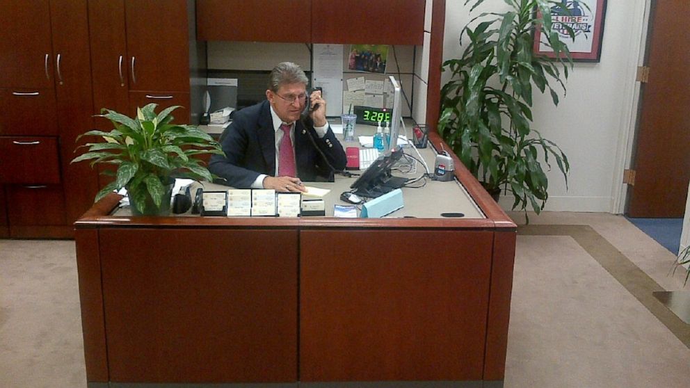 PHOTO: West Virginia Senator Joe Manchin is seen answering his own phones during the government shutdown. 