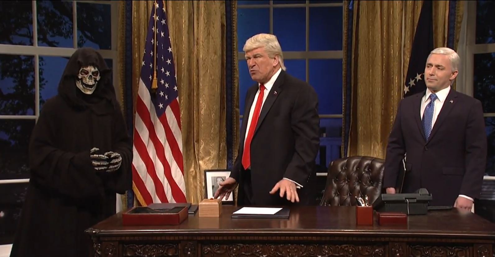 PHOTO: Alec Baldwin, portraying Donald Trump, is flanked by "Saturday Night Live" cast member Beck Bennett as Mike Pence, and the Grim Reaper, who is supposed to be White House chief strategist Steve Bannon, on "Saturday Night Live" on April 15, 2017.