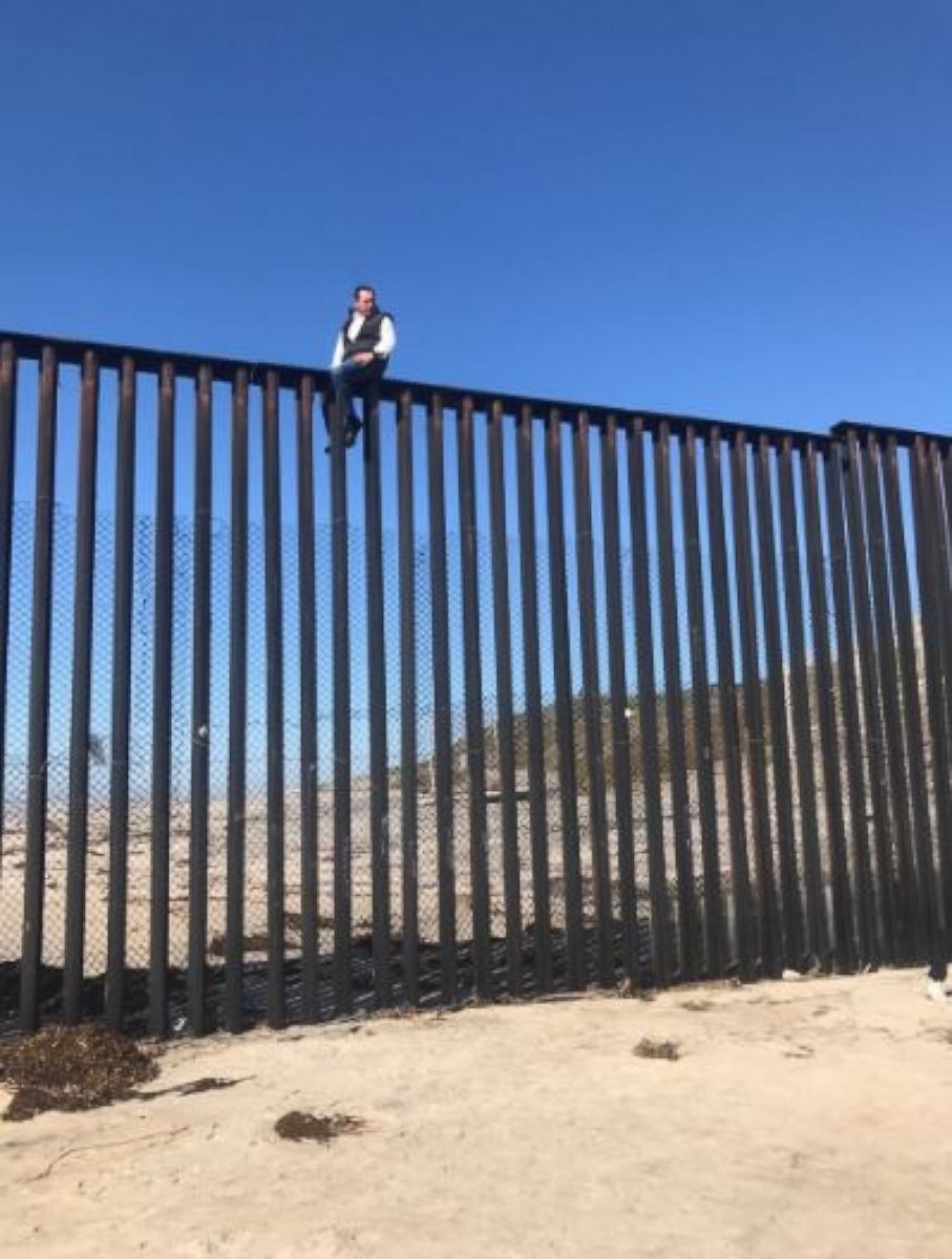 PHOTO: Mexican congressman Braulio Guerra sits atop the U.S.-Mexico border wall that divides Tijuana, Mexico, from California on March 1, 2017.