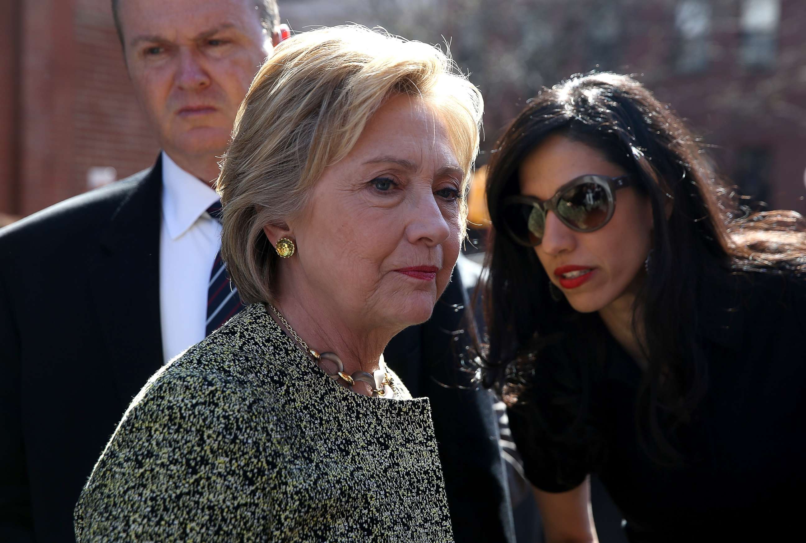 PHOTO: Democratic presidential candidate former Secretary of State Hillary Clinton (L) talks with aide Huma Abedin (R) before speaking at a neighborhood block party on April 17, 2016 in New York City. 