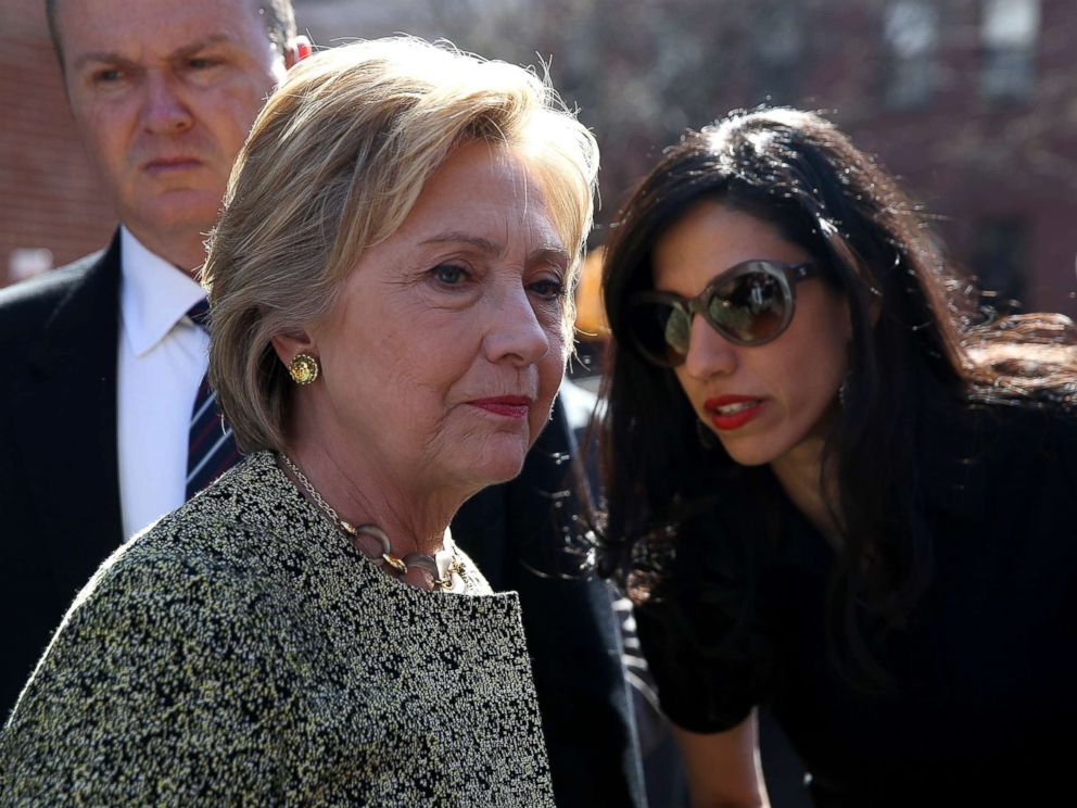 PHOTO: Democratic presidential candidate former Secretary of State Hillary Clinton (L) talks with aide Huma Abedin (R) before speaking at a neighborhood block party on April 17, 2016 in New York City.
