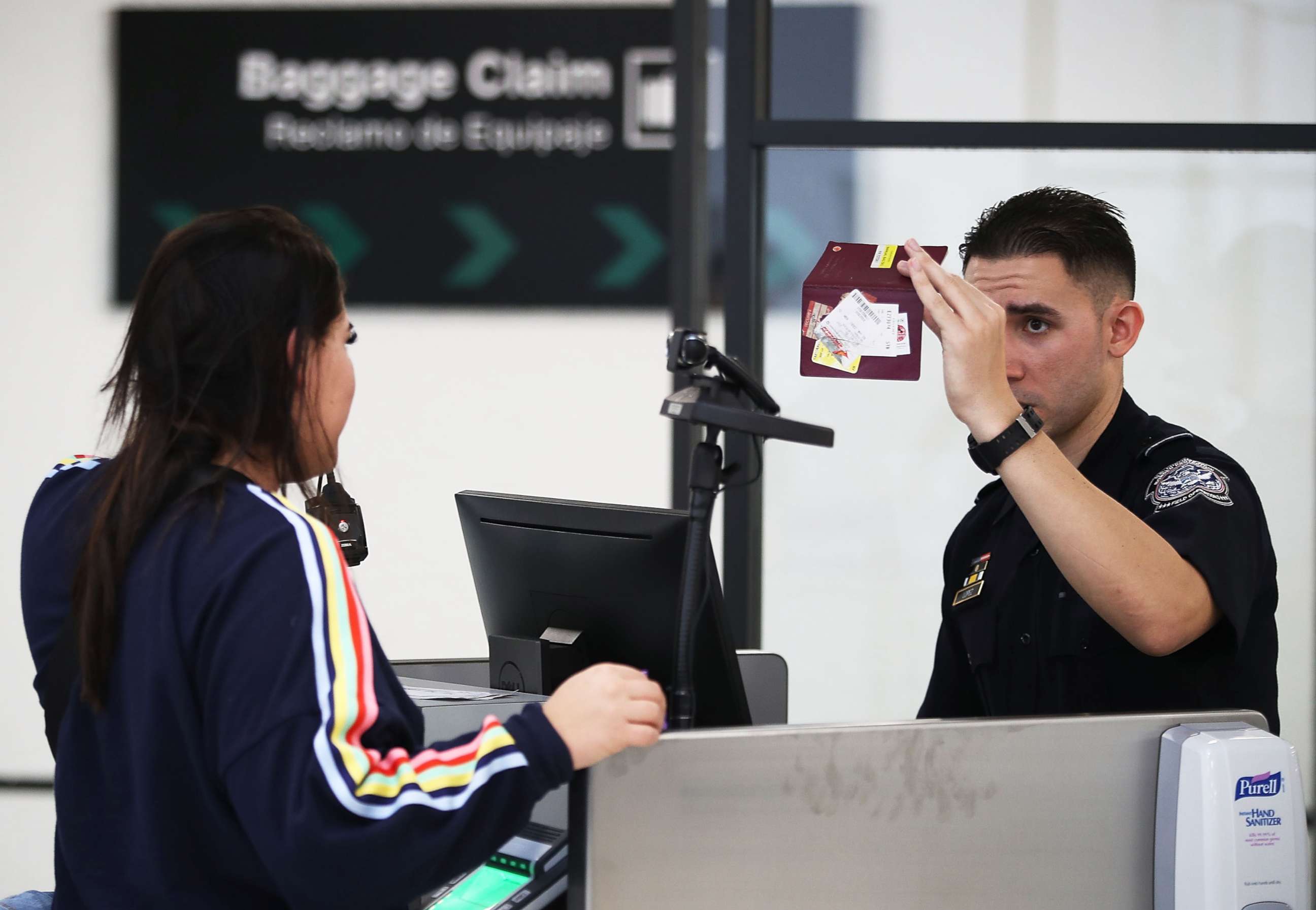PHOTO: A U.S. Customs and Border Protection officer inspects a passport at Miami International Airport to screen a traveler entering the U.S. in Miami, Feb. 27, 2018.