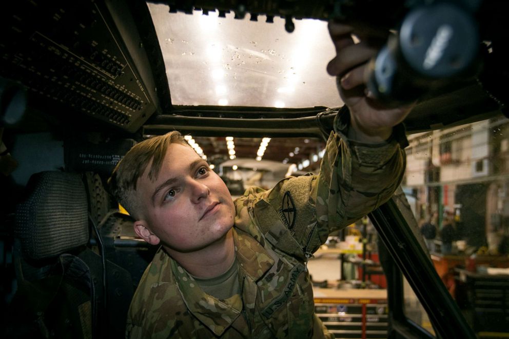 PHOTO: U.S. Army Pvt. Hunter Nines from Company A, 3rd General Support Aviation Battalion, 10th Combat Aviation Brigade inspects cockpit flight controls inside a UH-60M Blackhawk helicopter at Fort Drum, N.Y. on Oct. 4, 2019.