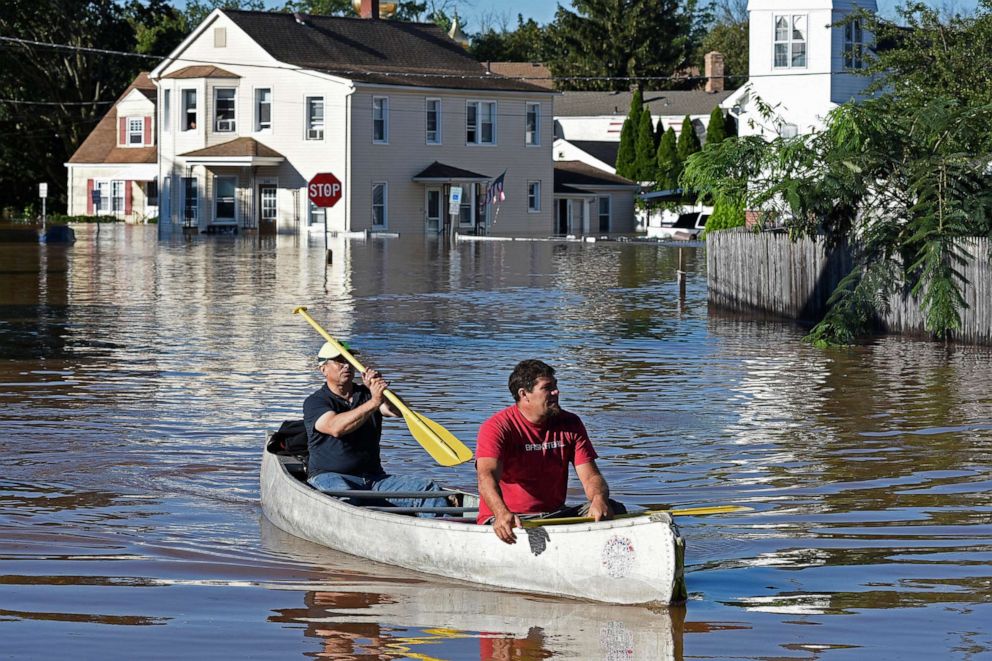 PHOTO:  Residents canoe through floodwater in the aftermath of Hurricane Ida in Manville, N.J., Sept. 2, 2021.