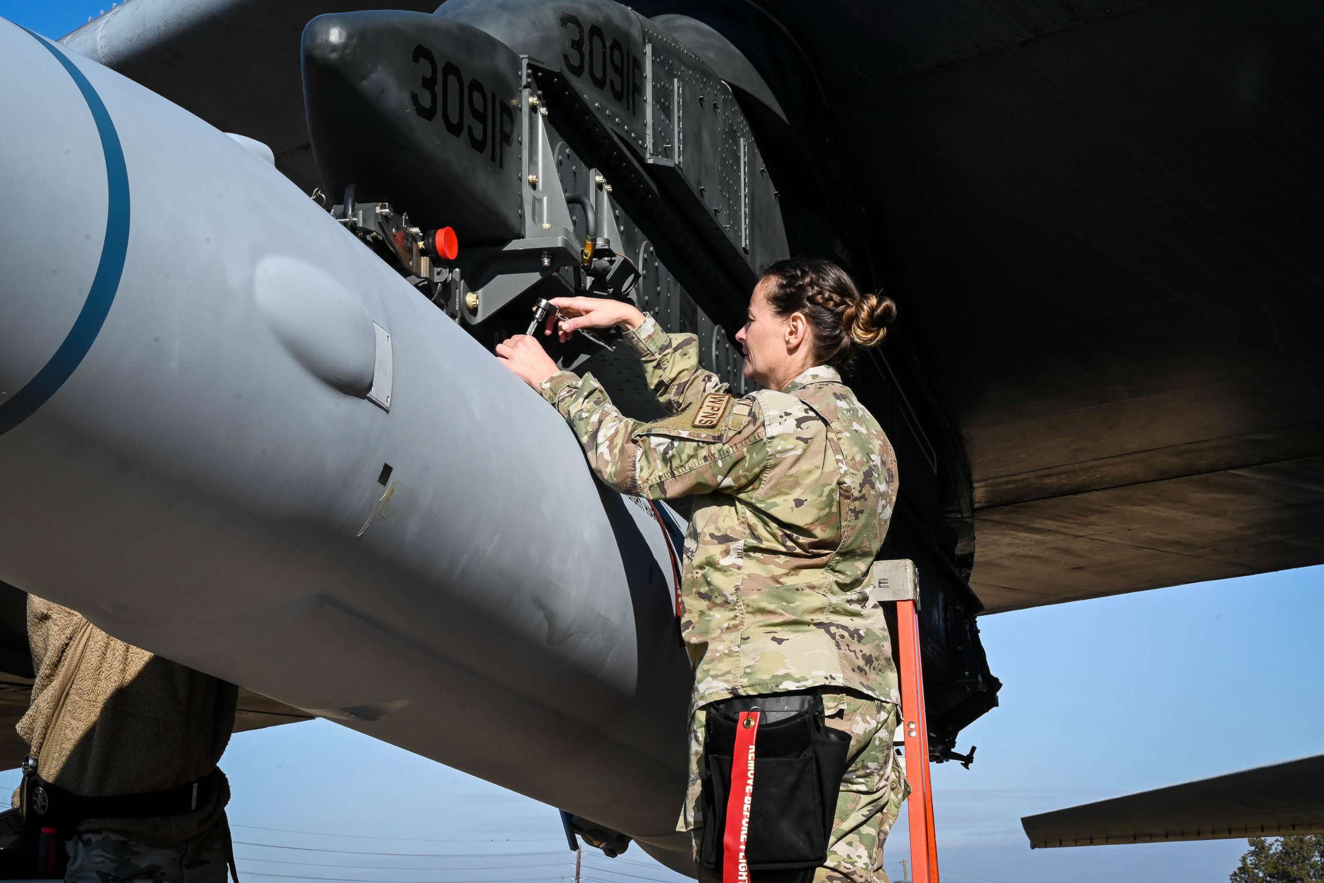 PHOTO: FILE - U.S. Air Force Master Sgt. Marcella Philips, 2nd Maintenance Group weapons standardization loading standardization crew chief, tightens bolts to secure the weapon to a B-52H Stratofortress, at Barksdale Air Force Base Louisiana, Nov. 2, 2022
