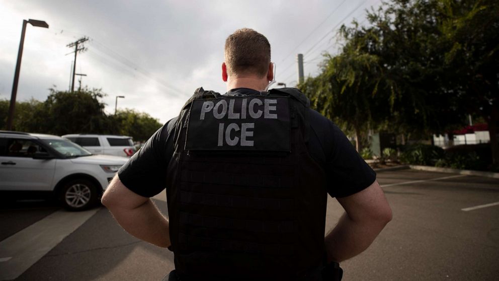 PHOTO: In this July 8, 2019, file photo, a U.S. Immigration and Customs Enforcement (ICE) officer looks on during an operation in Escondido, Calif.
