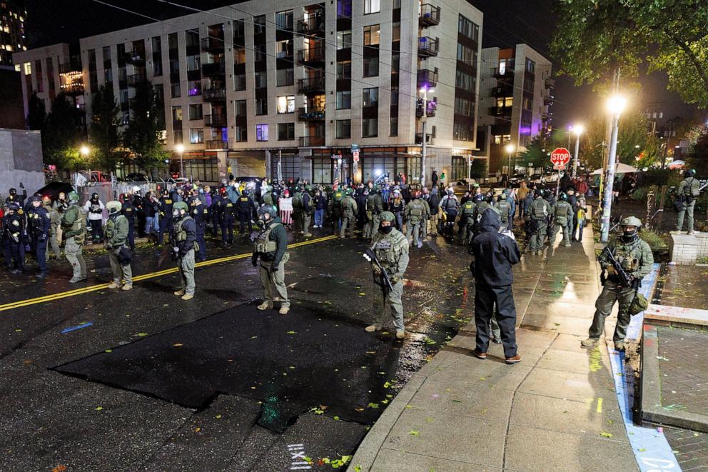 PHOTO: In this file photo, federal officers stand guard outside the Immigration and Customs Enforcement (ICE) facility as protests and counter-protests continue in Portland, Oregon, U.S., Oct. 25, 2025.