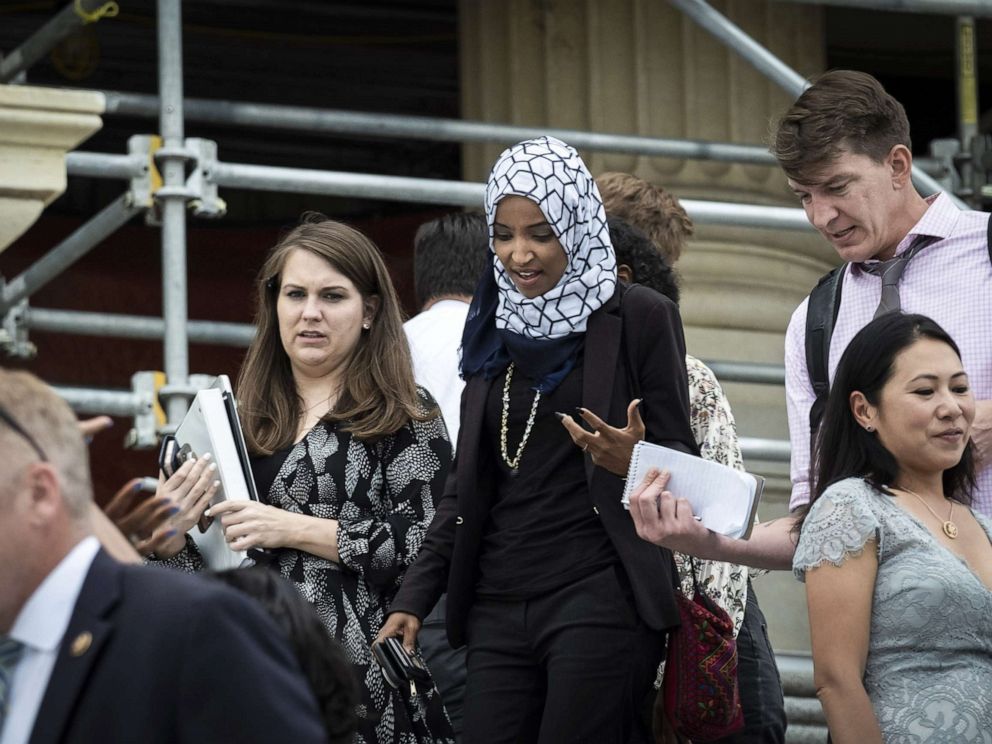 PHOTO: Rep. Ilhan Omara speaks to a reporter after voting for a resolution denouncing comments by President Trump targeting herself and three other progressive Democratic congresswomen of color, July 16, 2019, in Washington, DC.