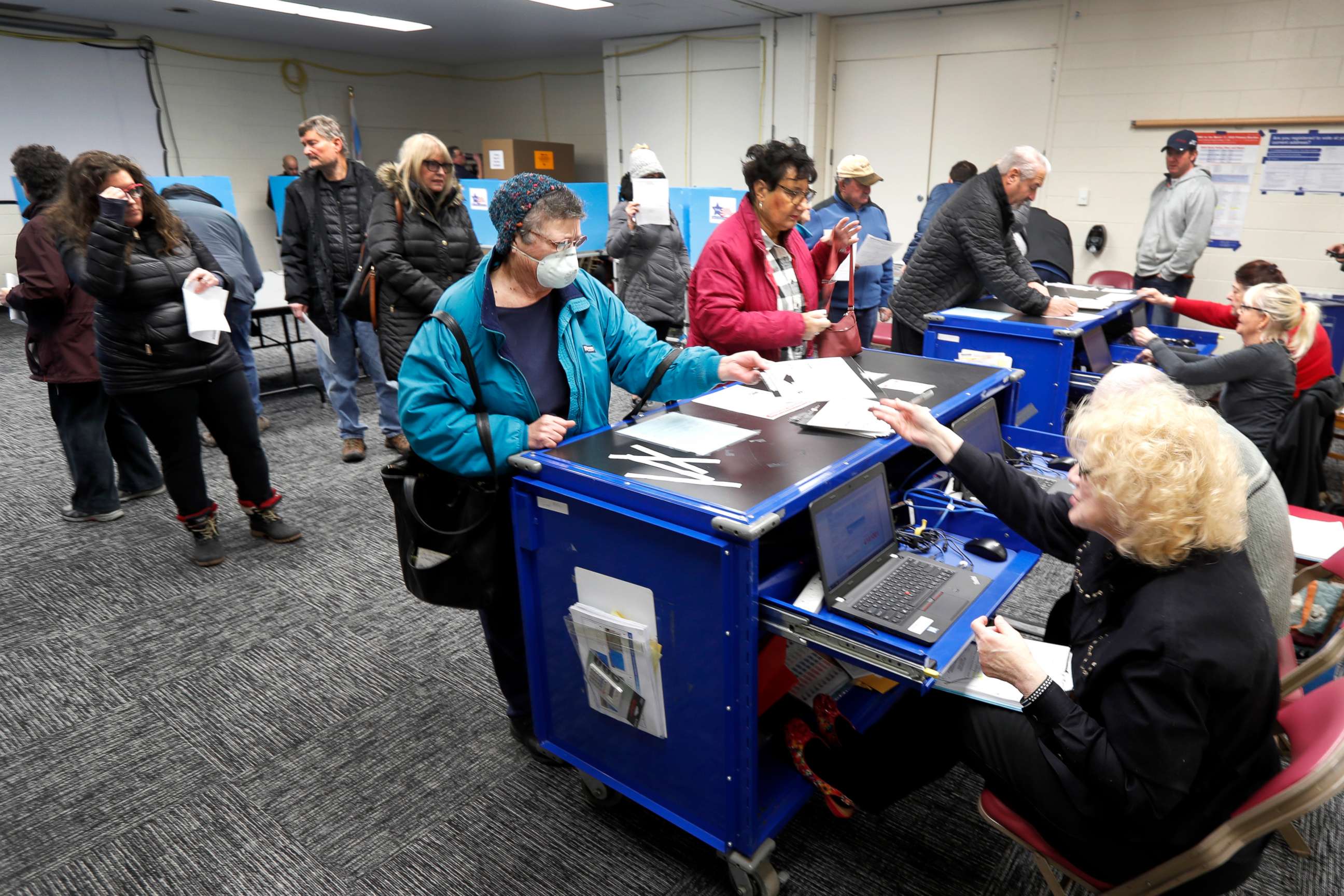 PHOTO: Chicago residents line up for early voting at the Roden Library Monday, March 16, 2020, in Chicago. 