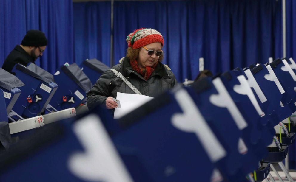 PHOTO: Chicago resident Sonja Russell walks up to a voting machine to cast her ballot in Illinois primary elections at the city's new early voting super site in downtown Chicago, March 13, 2018.