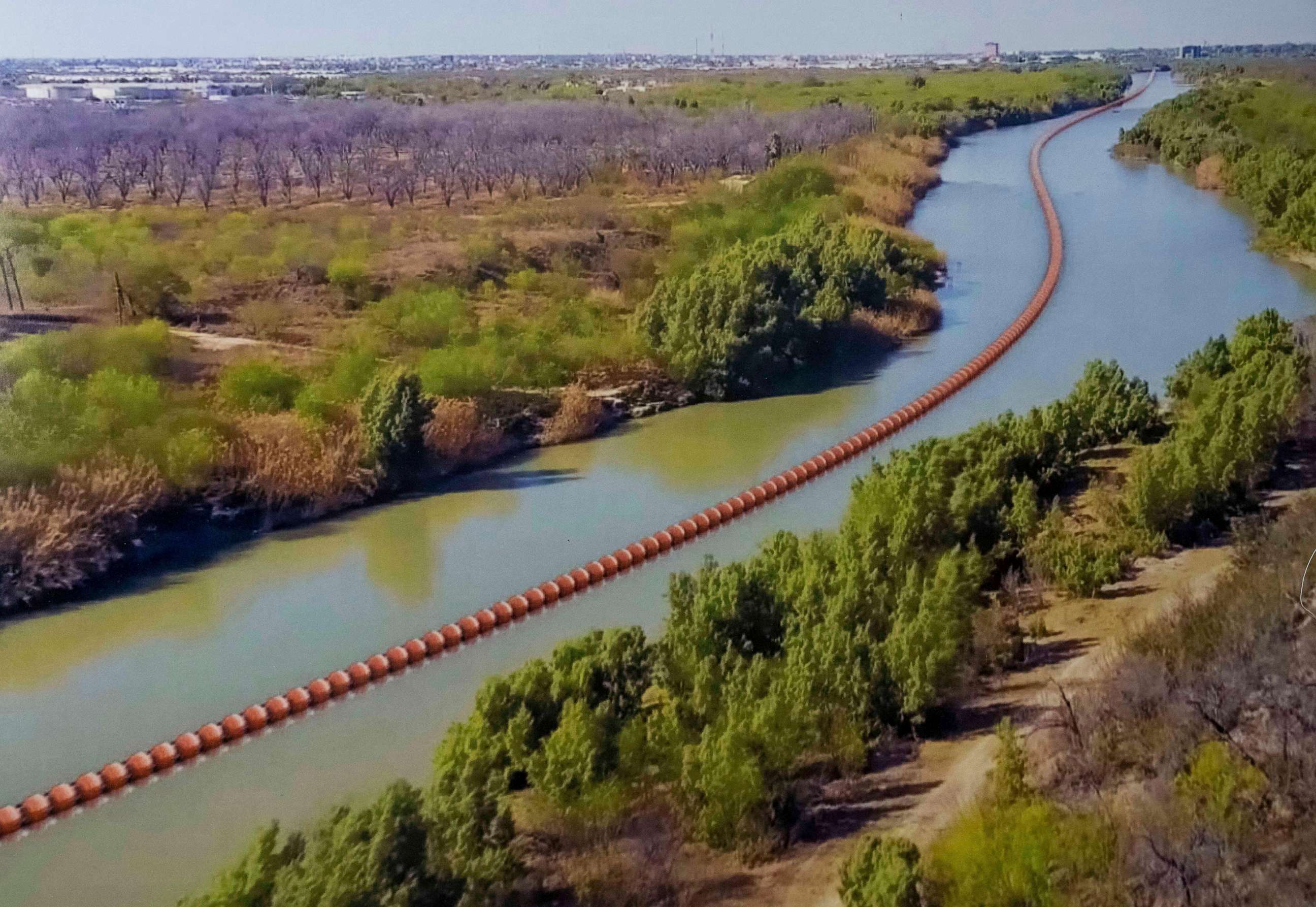 PHOTO: An illustration of a floating barrier in the Rio Grande River of Texas displayed by Texas Republican Governor Abbott as he signed several bills on June 8, 2023, to strengthen Texas border security.