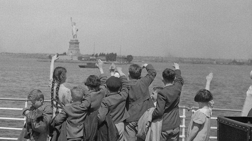 PHOTO: A group of young Austrian immigrants wave to the Statue of Liberty upon their arrival in America aboard the S.S. Harding. The fifty Jewish children, who were greeted by their new adoptive families, were fleeing Nazi persecution in their homeland.