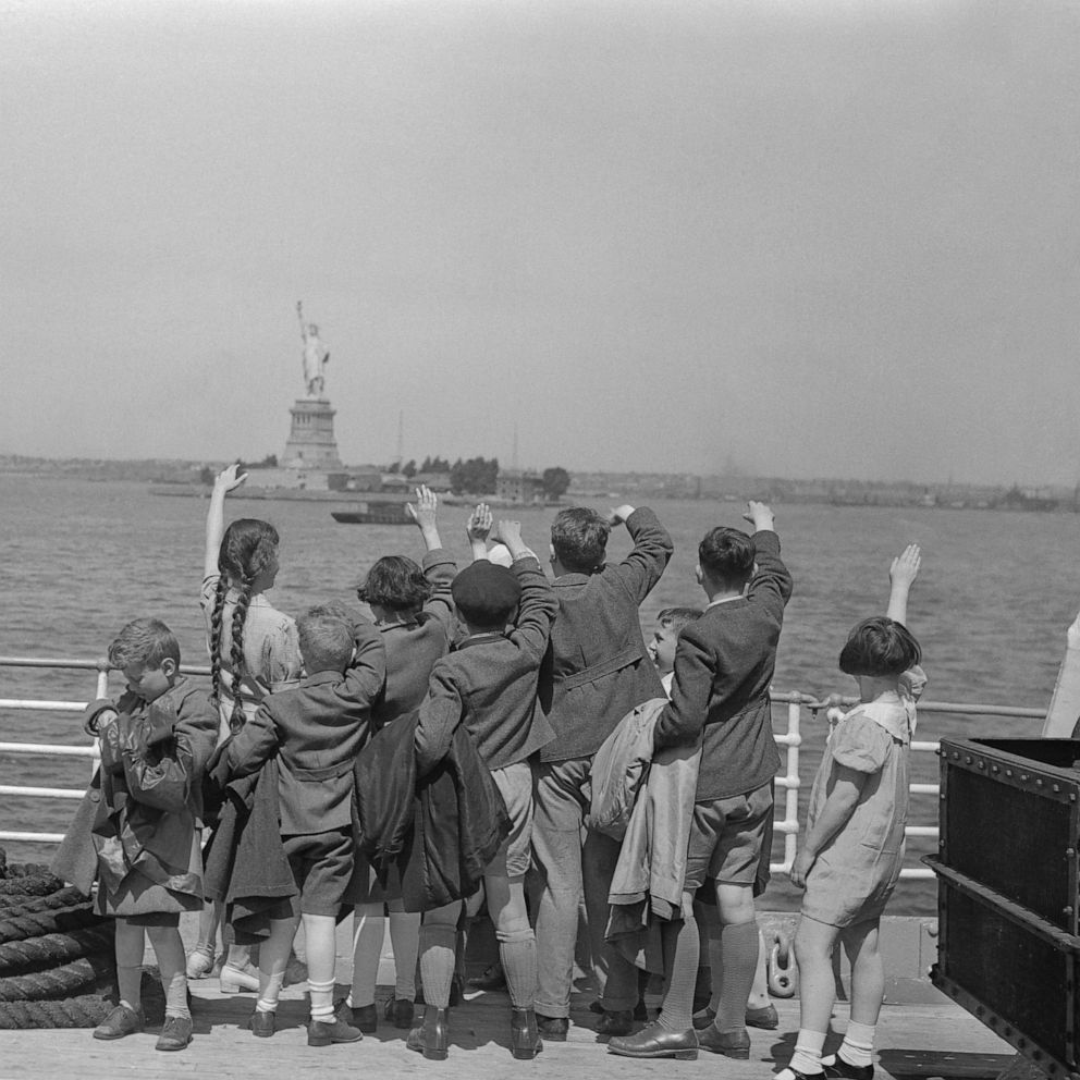 PHOTO: A group of young Austrian immigrants wave to the Statue of Liberty upon their arrival in America aboard the S.S. Harding. The fifty Jewish children, who were greeted by their new adoptive families, were fleeing Nazi persecution in their homeland.