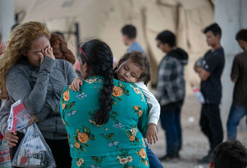 PHOTO: Immigrants wait to be interviewed by U.S. Border Patrol agents after they were taken into custody on July 02, 2019 in McAllen, Texas.