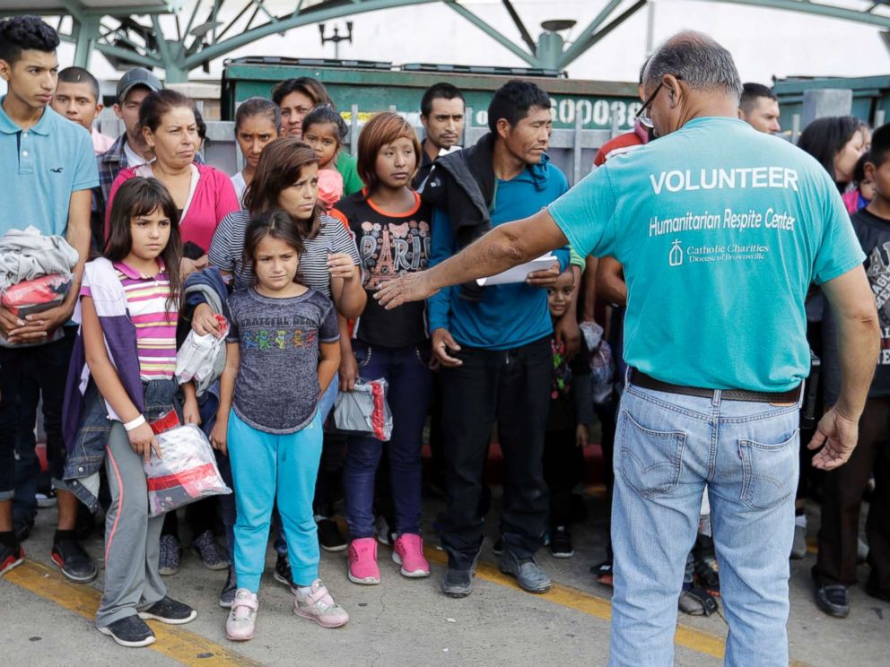 PHOTO: Immigrants are helped by a volunteer at the bus station after they were processed and released by U.S. Customs and Border Protection, June 22, 2018, in McAllen, Texas.