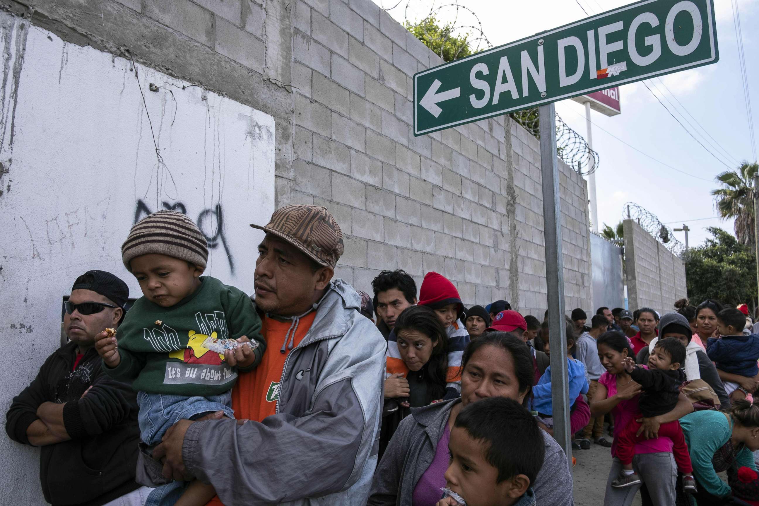 PHOTO: Central American migrants queue outisde the Padre Chava's kitchen soup for breakfast and legal counseling, in Tijuana, Mexico,April 27, 2018. 