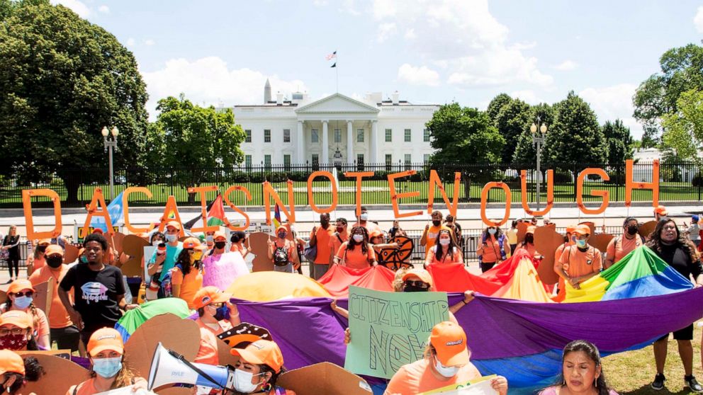 PHOTO: Protesters holding a sign that reads "DACA Is Not Enough" stand in front of the White House at a DACA rally in Lafayette Square Park in Washington, June 15, 2021.
