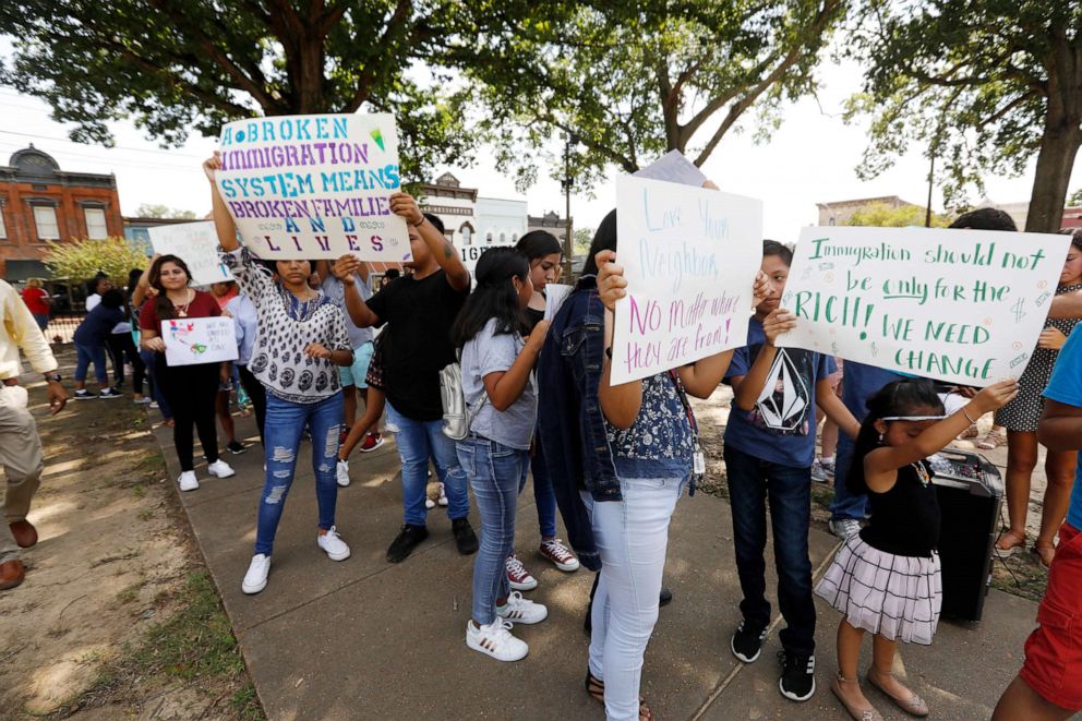 PHOTO: Children of mainly Latino immigrant parents hold signs in support of them and those who were picked up during an immigration raid at a food processing plant, during a protest march to the Madison County Courthouse in Canton, Miss., Aug. 11, 2019.