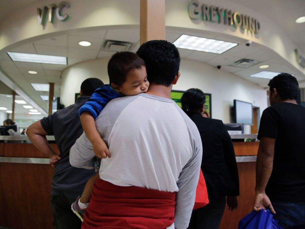 PHOTO: A group of immigrants from Honduras and Guatemala seeking asylum stand in line at the bus station after they were processed and released by U.S. Customs and Border Protection, June 21, 2018, in McAllen, Texas.