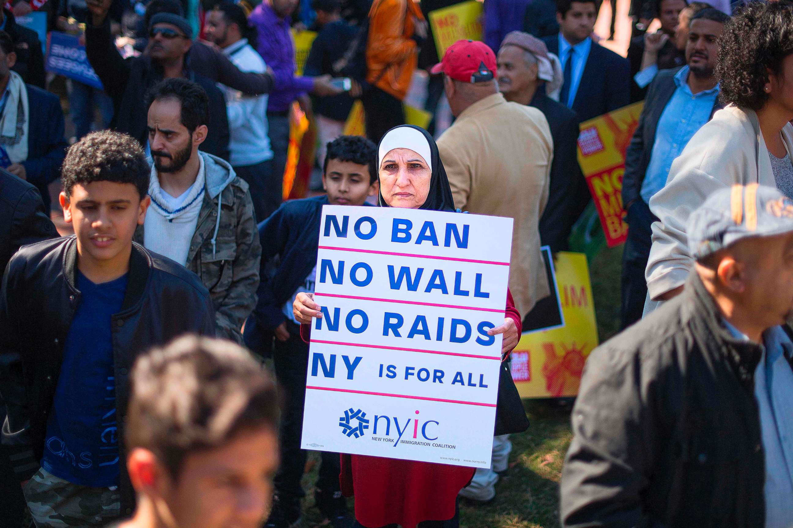 PHOTO: A demonstrator holds up a placard as other pass by during a #NoMuslimBanEver rally and march in Washington, D.C., Oct. 18, 2017.