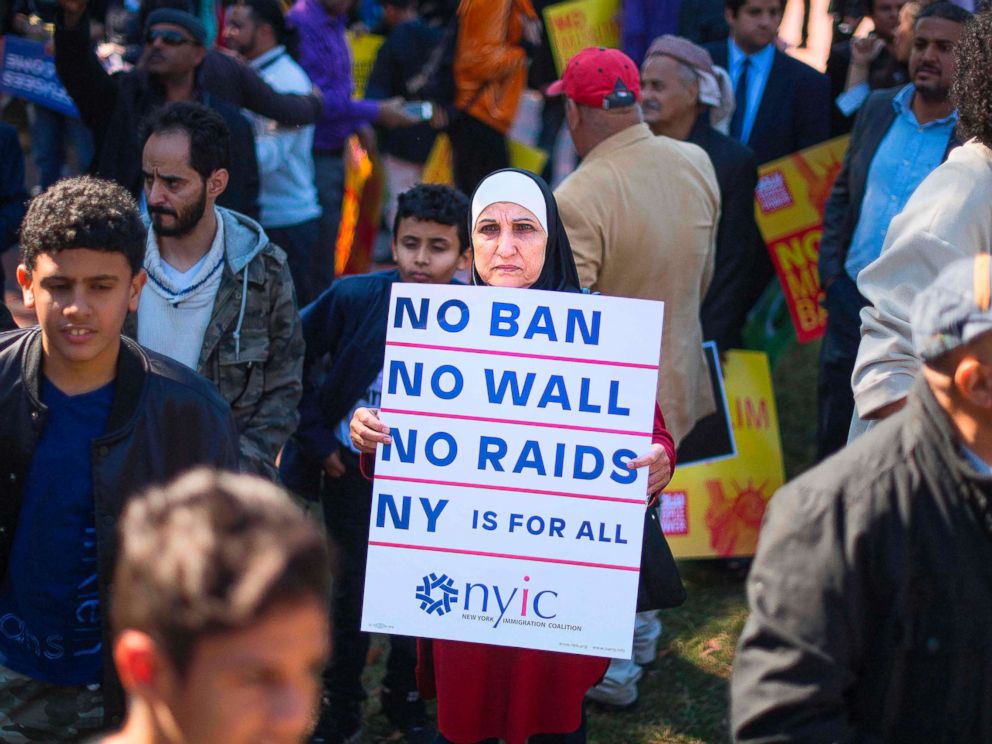 PHOTO: A demonstrator holds up a placard as other pass by during a #NoMuslimBanEver rally and march in Washington, D.C., Oct. 18, 2017.