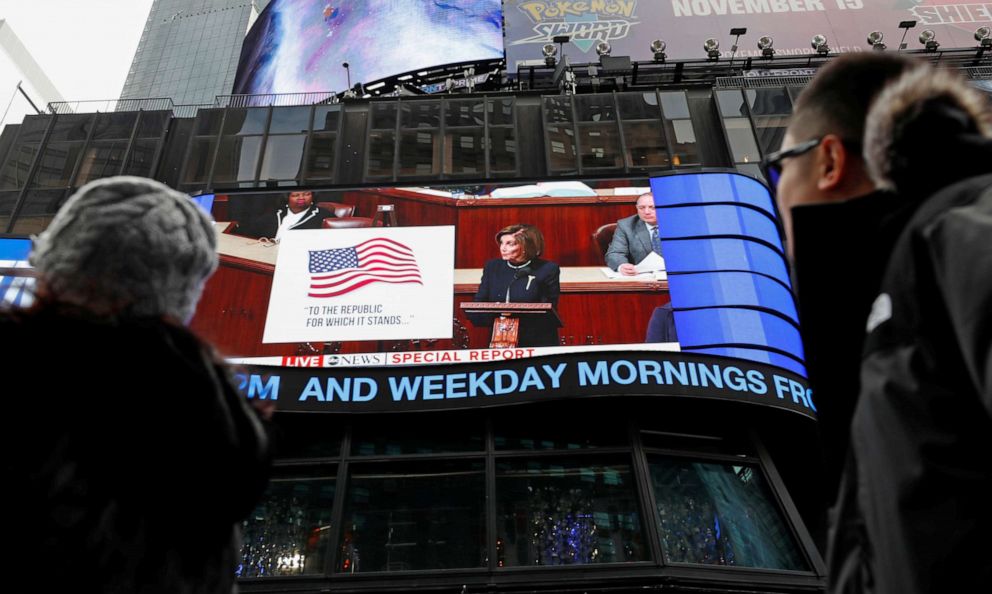 PHOTO: House Speaker Nancy Pelosi is seen on a giant screen outside ABC News studios in Times Square, speaking to the U.S. House of Representatives, in New York, Dec. 18, 2019.