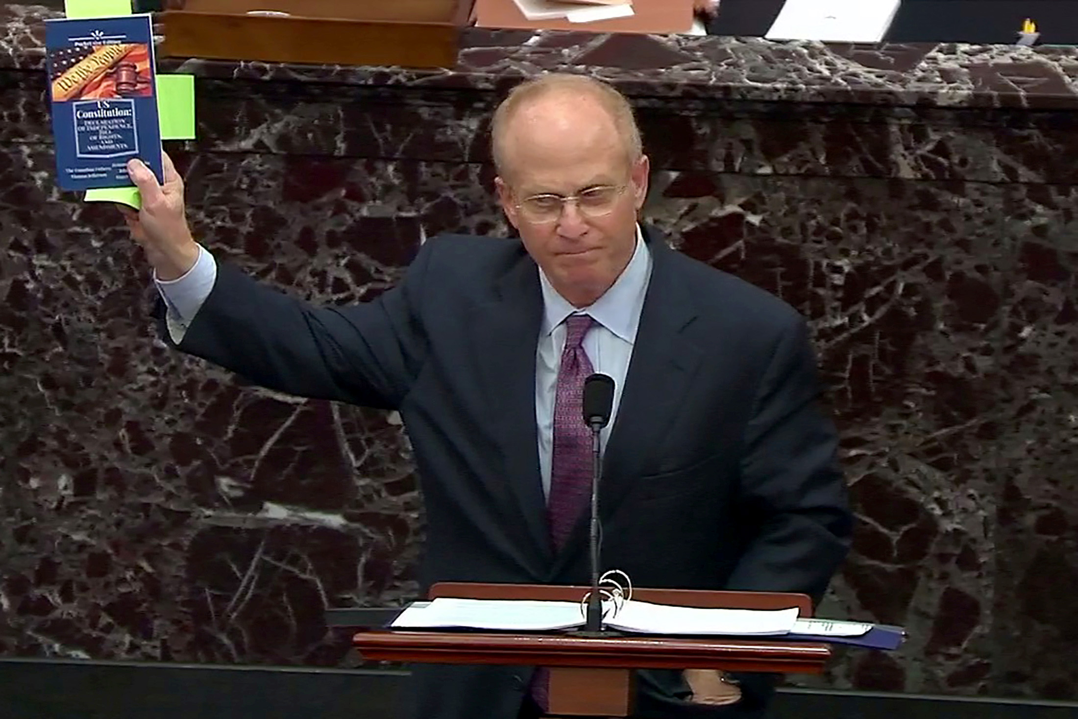 PHOTO: Attorney David Schoen, representing and defending former President Donald Trump, holds up a handbook on the constitution as he addresses the senate as it begins the second impeachment trial on Capitol Hill in Washington, Feb. 9, 2021.