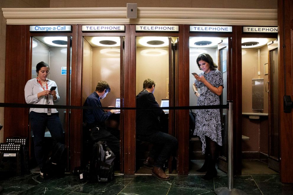 PHOTO: Journalists file after the arrival of the two witnesses in public impeachment hearings, Nov. 13, 2019, on Capitol Hill in Washington.