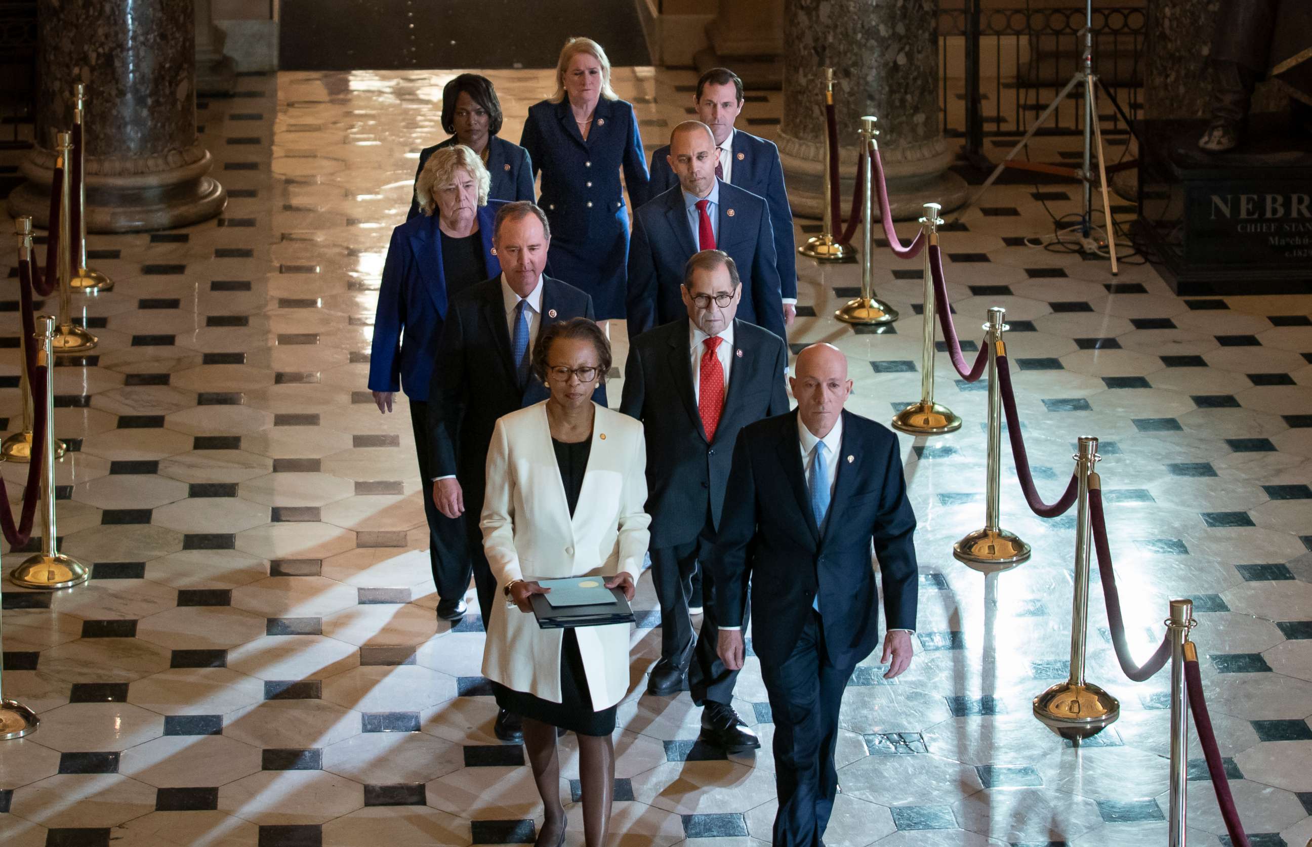 PHOTO: Clerk of the House Cheryl Johnson, left, and House Sergeant at Arms Paul Irving pass through Statuary Hall at the Capitol to deliver the articles of impeachment against President Donald Trump to the Senate, Wednesday, Jan. 15, 2020.