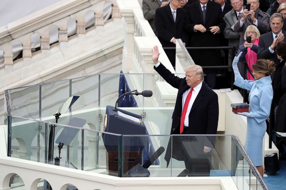 PHOTO: President Donald Trump and his wife Melania Trump wave after he took the oath of office on the West Front of the Capitol on Jan. 20, 2017.