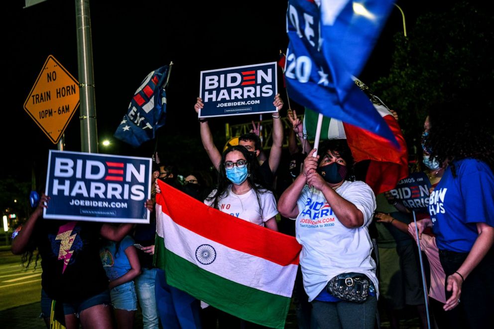 PHOTO: A supporter holds a national flag of India as she attends a watch party of President-elect Joe Biden and Vice President-elect Kamala Harris as they deliver remarks in Miami, Nov. 7, 2020.