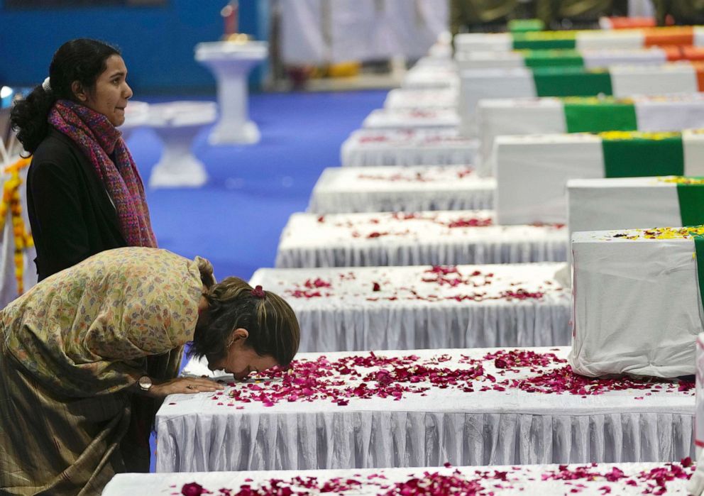 PHOTO: People console family members of victims of the helicopter crash after their caskets arrived at Palam airport in New Delhi, Dec. 9, 2021. 