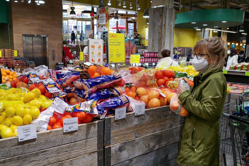 PHOTO: A shopper bags fruit inside a supermarket in Chevy Chase, Md.. Feb. 17, 2022.