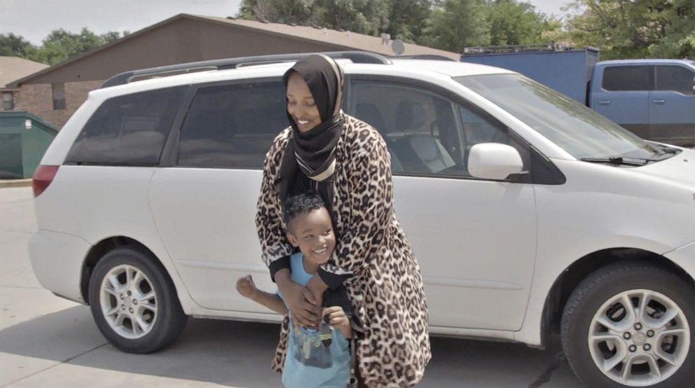 PHOTO: Garden City, Kansas, resident Halima Farah hugs a neighbor’s young son in the parking lot of 312 West Mary Street.