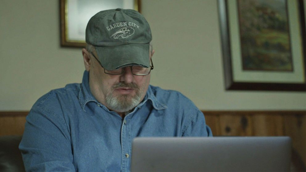 PHOTO: Former FBI informant Dan Day uses a laptop, July 2021.